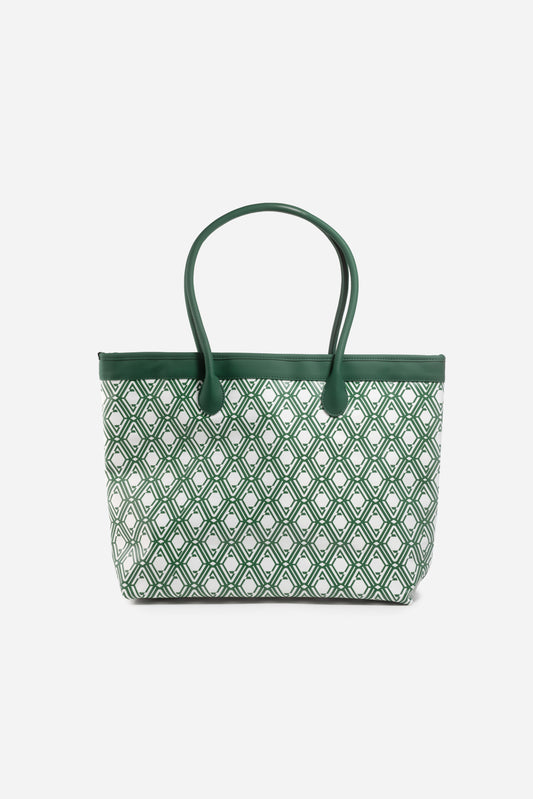Front view of The Monogram Bag in Evergreen with white and green geometric print and green leather handles
