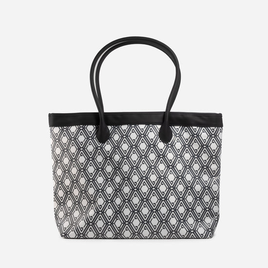 Front view of The Monogram Bag in Night Black with white and black geometric print and black handles