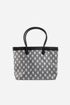 Front view of The Monogram Bag in Night Black with white and black geometric print and black handles