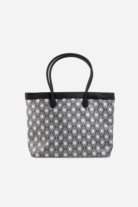 Front view of The Monogram Bag in Night Black with white and black geometric print and black handles