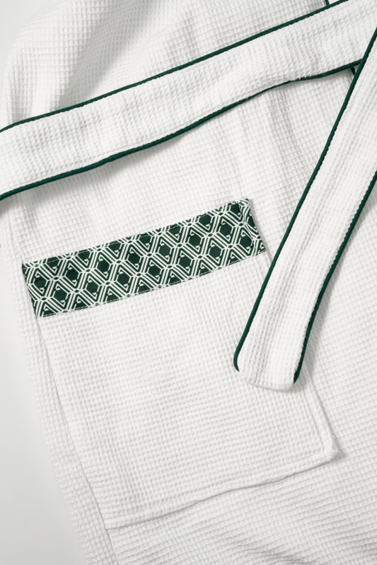 Waffle Robe pocket detail showing evergreen AURA monogram print trim