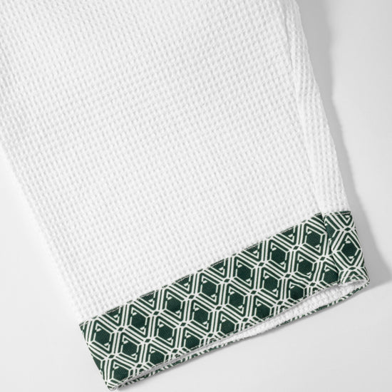 Waffle Robe cuff close-up showing evergreen AURA monogram print trim
