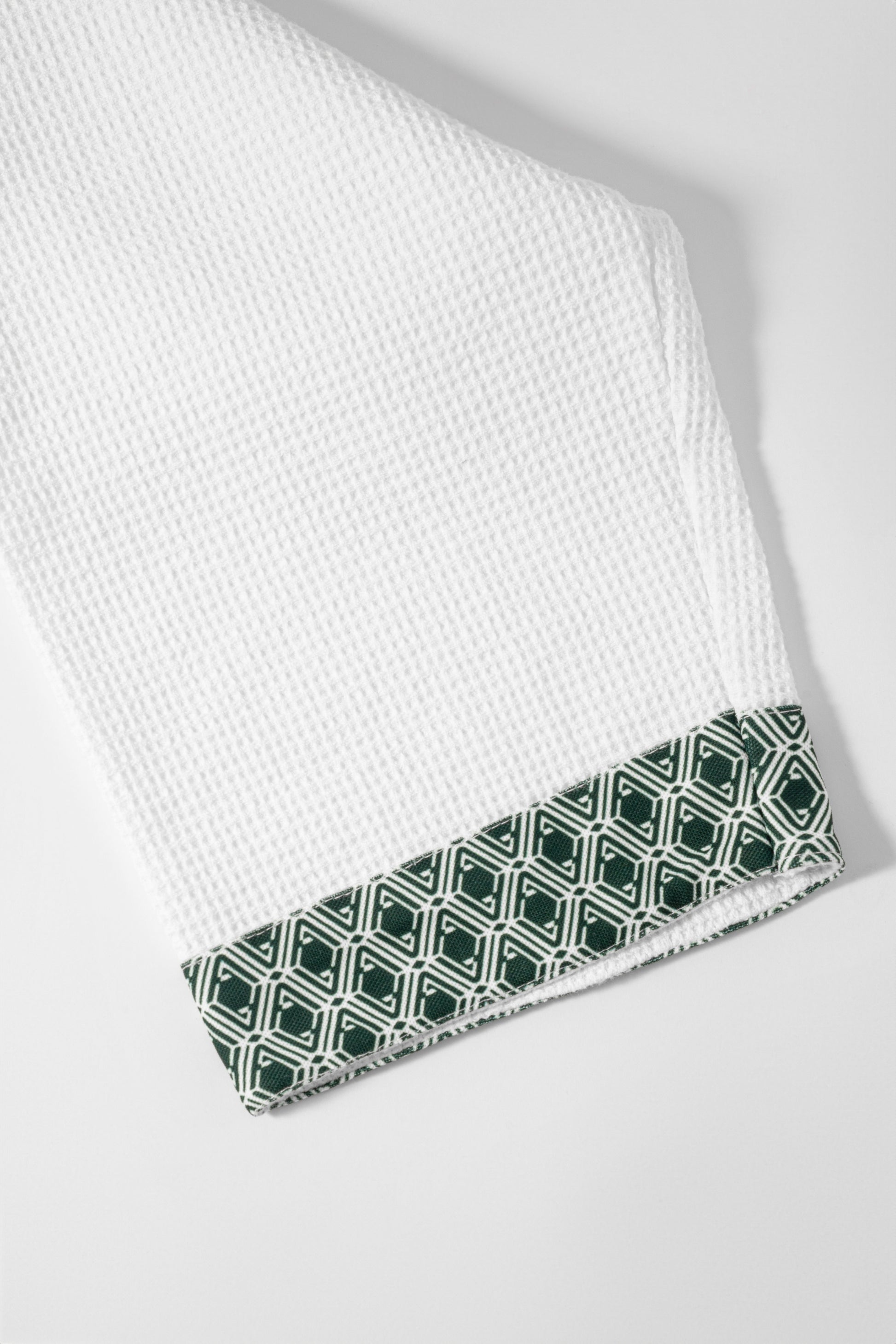 Waffle Robe cuff close-up showing evergreen AURA monogram print trim