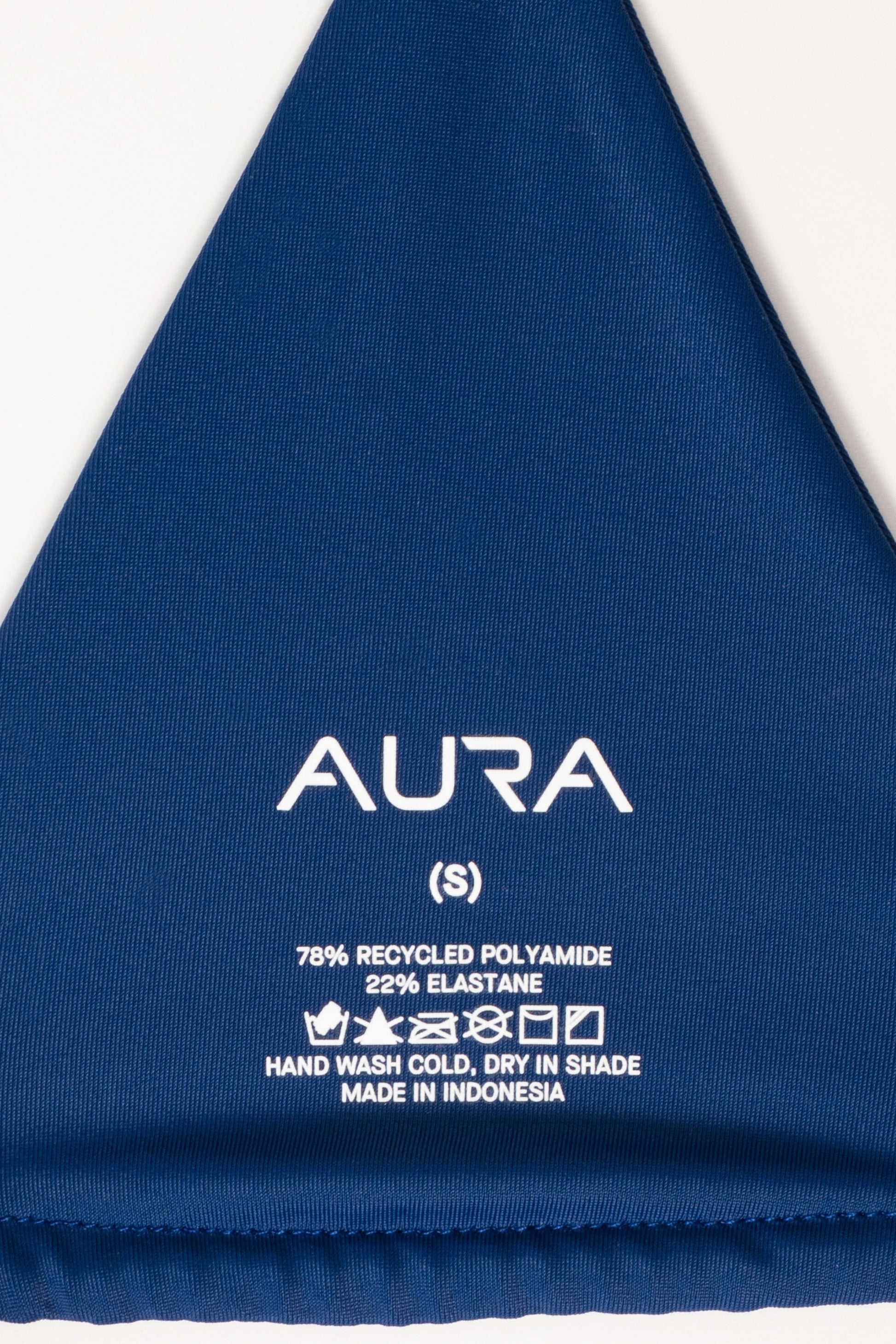 AURA Skypool care label on Nomad bikini top, 78% recycled polyamide 22% elastane, made in Indonesia