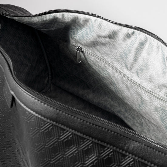 Pinnacle Duffle monogram black interior showing silver geometric-print lining