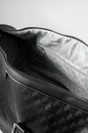 Pinnacle Duffle monogram black interior showing silver geometric-print lining