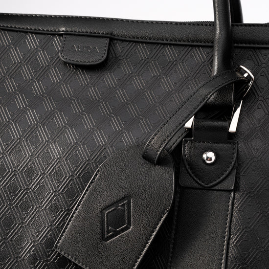 Pinnacle Duffle monogram black embossed AURA tab and matching leather luggage tag