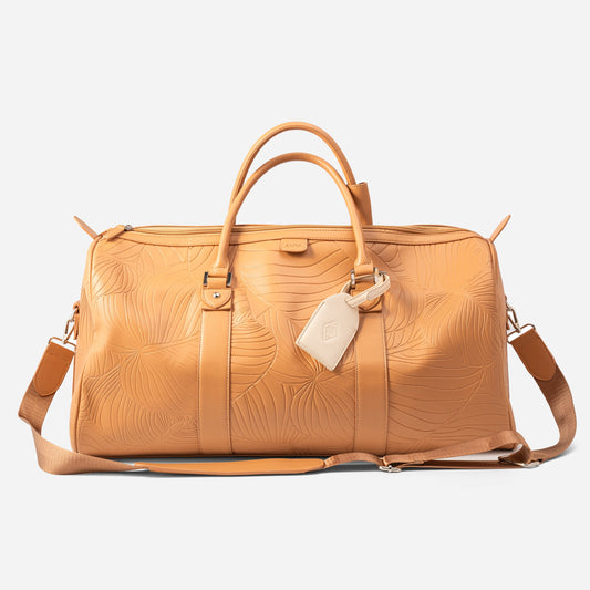 AURA Weekender Duffle in clay with leaf-embossed leather and webbing shoulder strap
