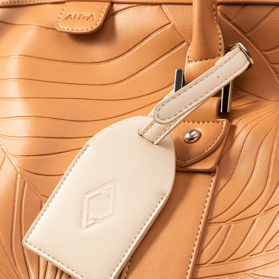Weekender Duffle clay luggage tag and embossed AURA logo detail