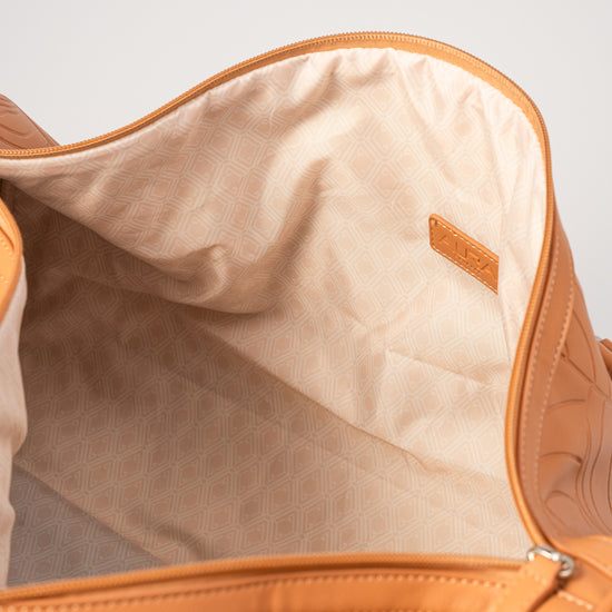 Weekender Duffle clay interior showing cream geometric-print lining