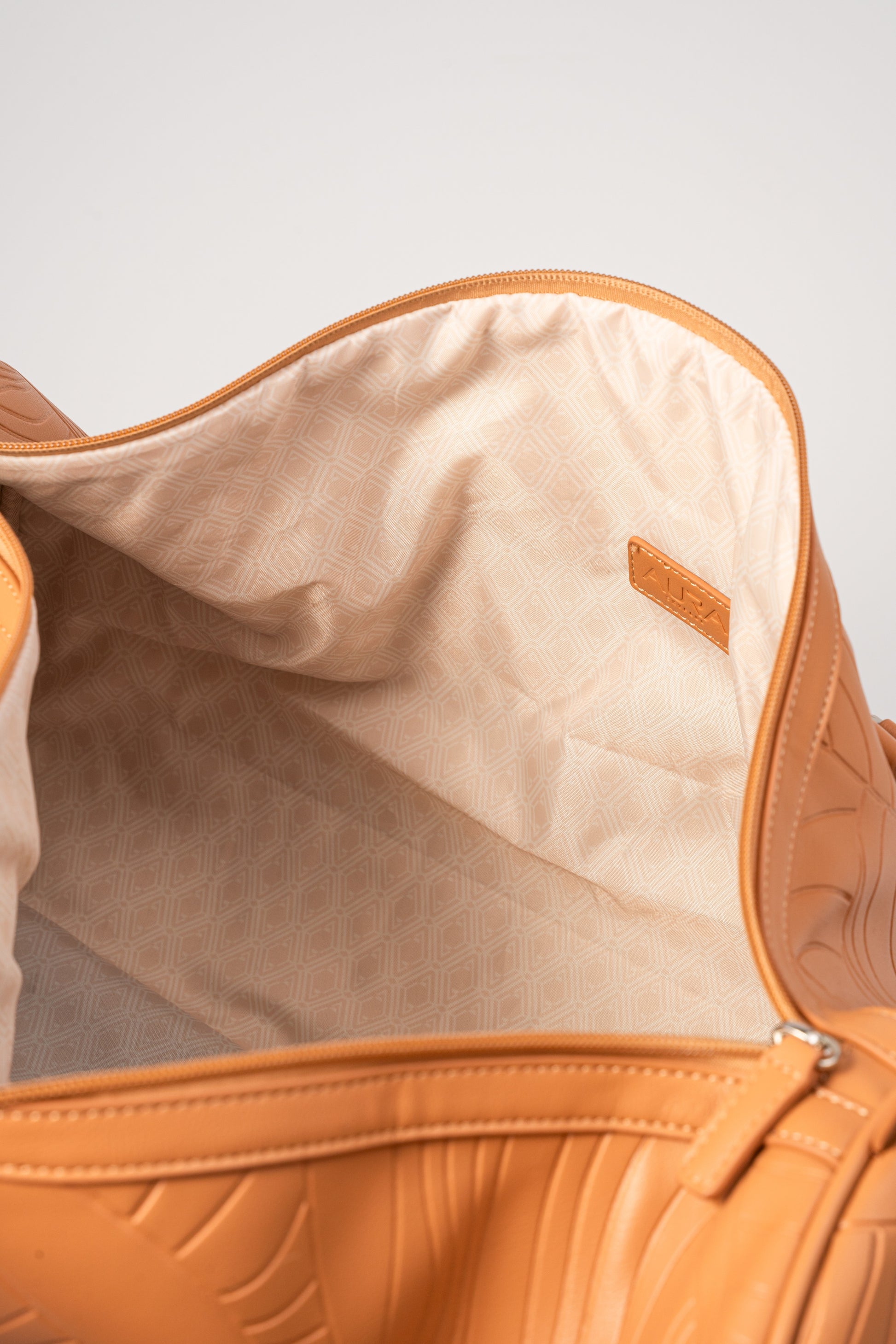 Weekender Duffle clay interior showing cream geometric-print lining