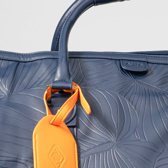 Weekender Duffle horizon blue handle and orange AURA luggage tag detail