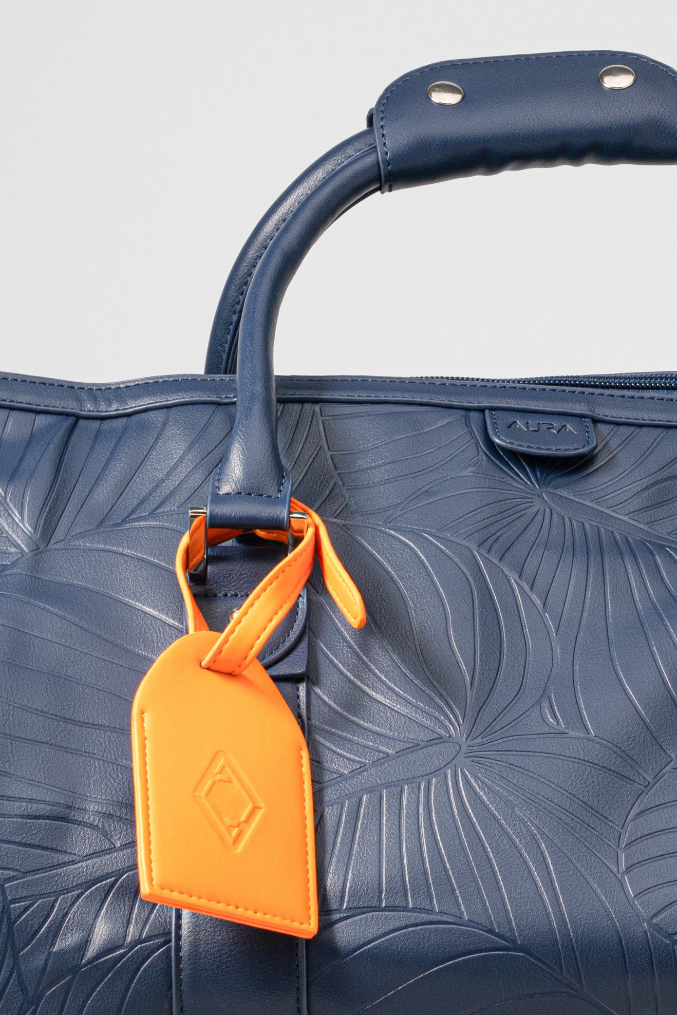 Weekender Duffle horizon blue handle and orange AURA luggage tag detail