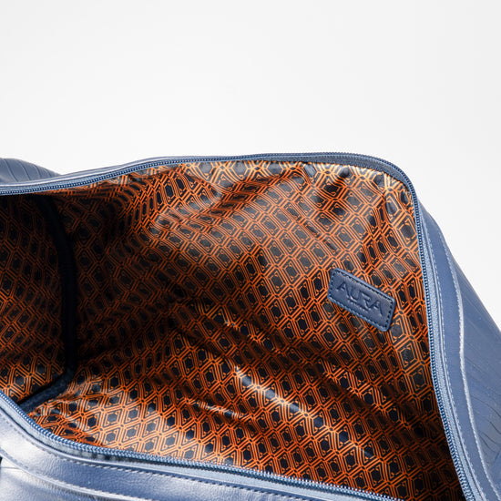 Weekender Duffle horizon blue interior showing rust geometric-print lining