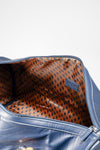 Weekender Duffle horizon blue interior showing rust geometric-print lining