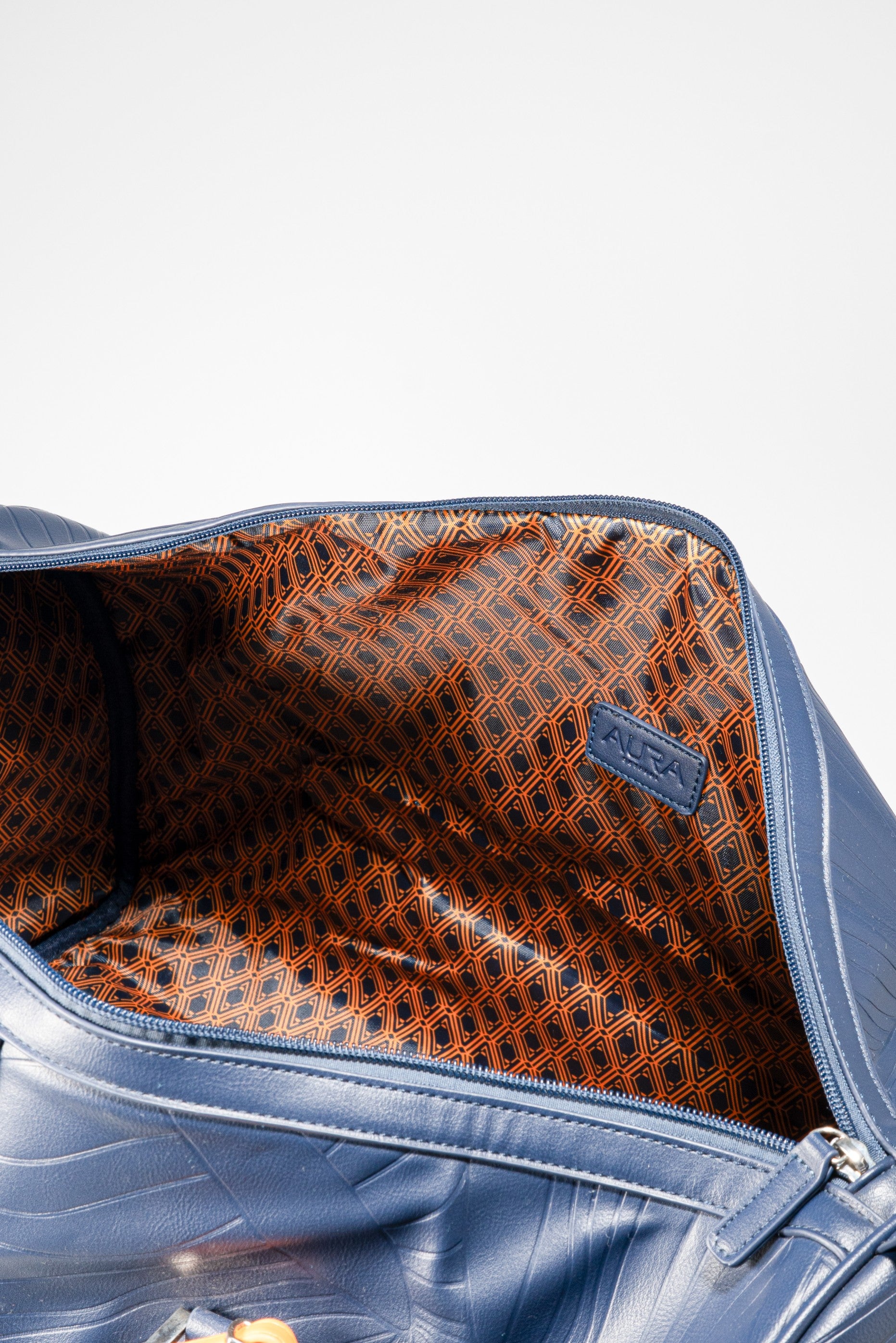 Weekender Duffle horizon blue interior showing rust geometric-print lining