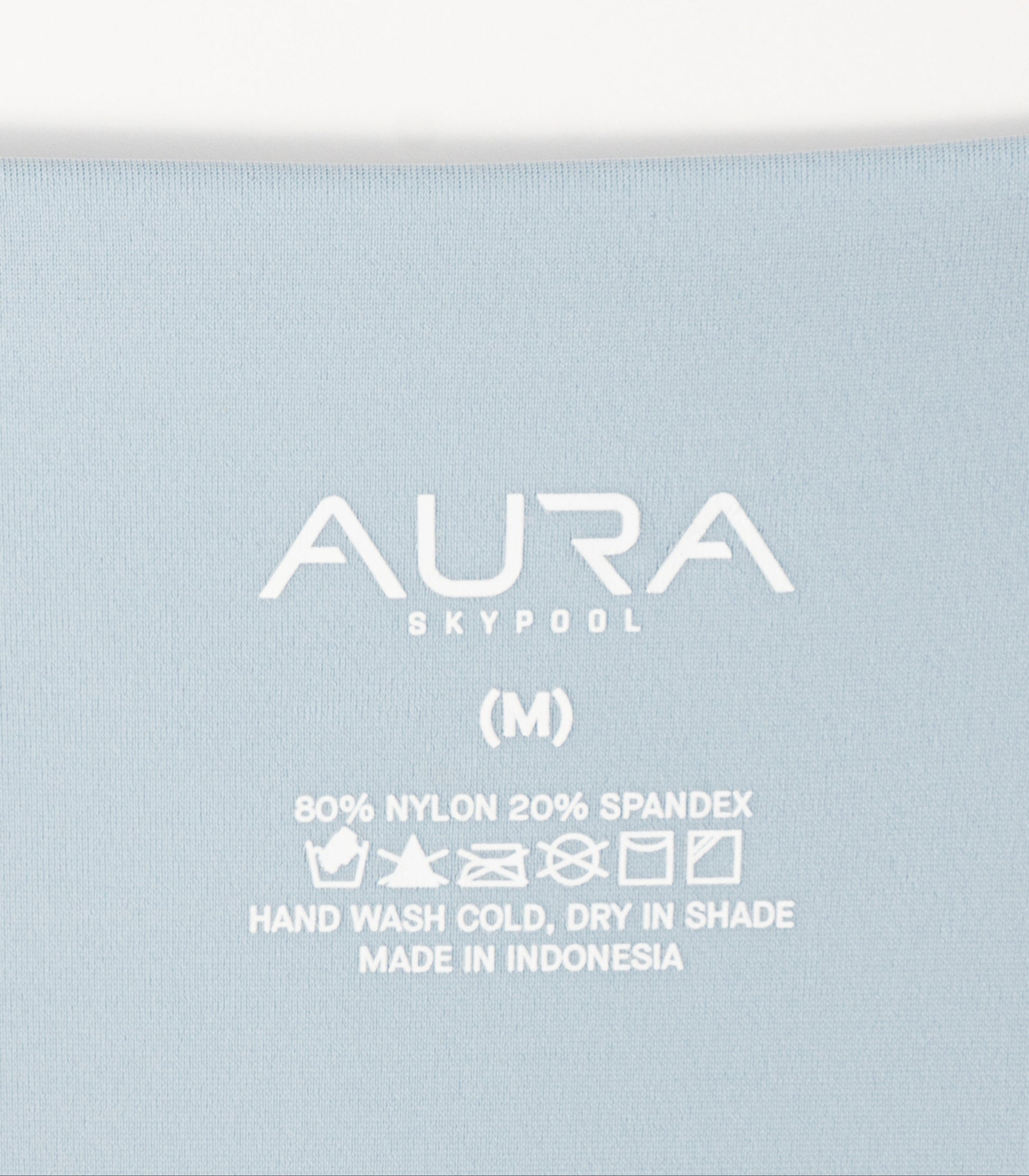 AURA Skypool care label on Solstice bikini top, 80% nylon 20% spandex, made in Indonesia
