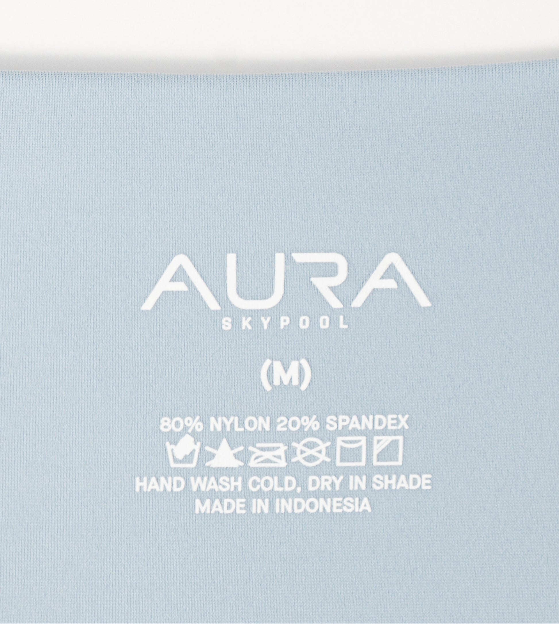 AURA Skypool care label on Solstice bikini bottom, 80% nylon 20% spandex, made in Indonesia