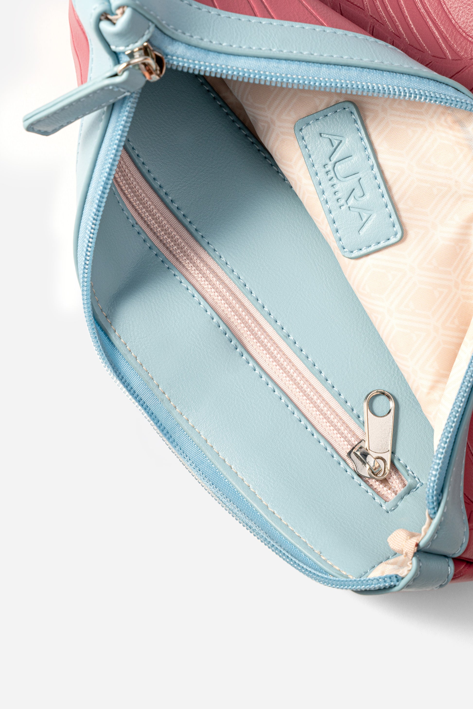 Travel Pouch in Berry, interior open with pale blue lining and blush zip