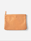 Travel Pouch in Clay, flat lay showing leaf-embossed leather and zip pull