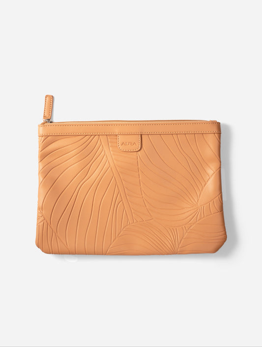 Travel Pouch in Clay, flat lay showing leaf-embossed leather and zip pull