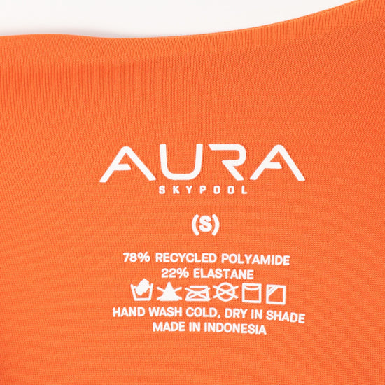 AURA care label on Velora swimsuit, 78% recycled polyamide 22% elastane, made in Indonesia