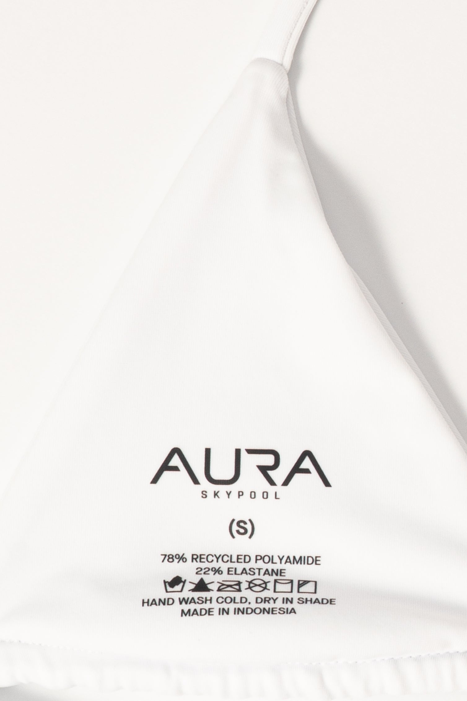AURA Skypool care label on Wanderess bikini top, 78% recycled polyamide 22% elastane, made in Indonesia
