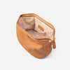 Wash bag clay interior open showing cream lining and embossed AURA tab