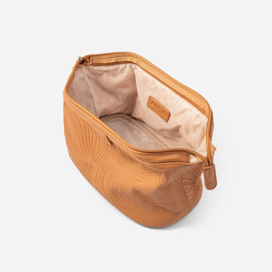 Wash bag clay interior open showing cream lining and embossed AURA tab